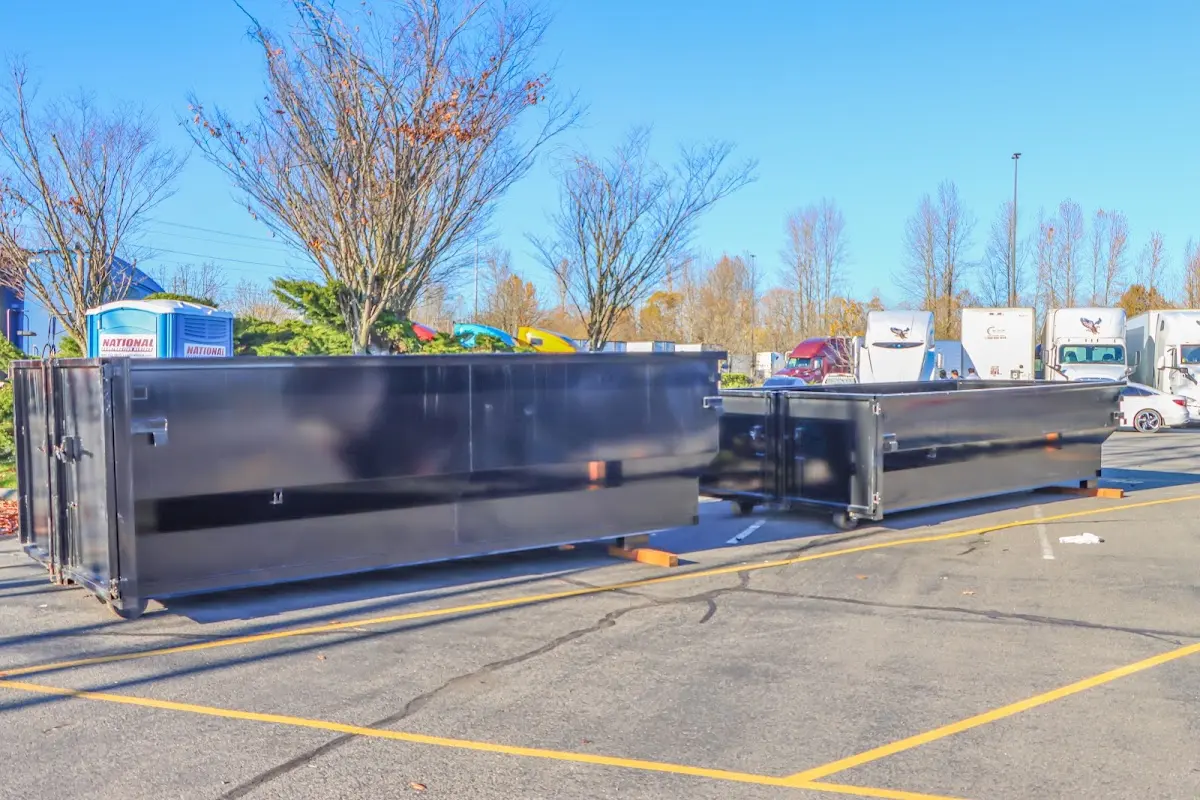 Professional dumpster rental service with roll-off container on residential driveway in Ephraim